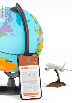 صورة لنموذج الكرة الأرضية وبجانبها جوال بداخله تطبيقات شركات السياحة والسفر
